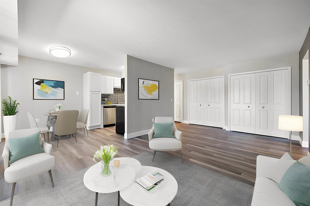 a living room with a couch and chairs and a table at Sunnymede Apartments - Troy, MI, Troy, Michigan