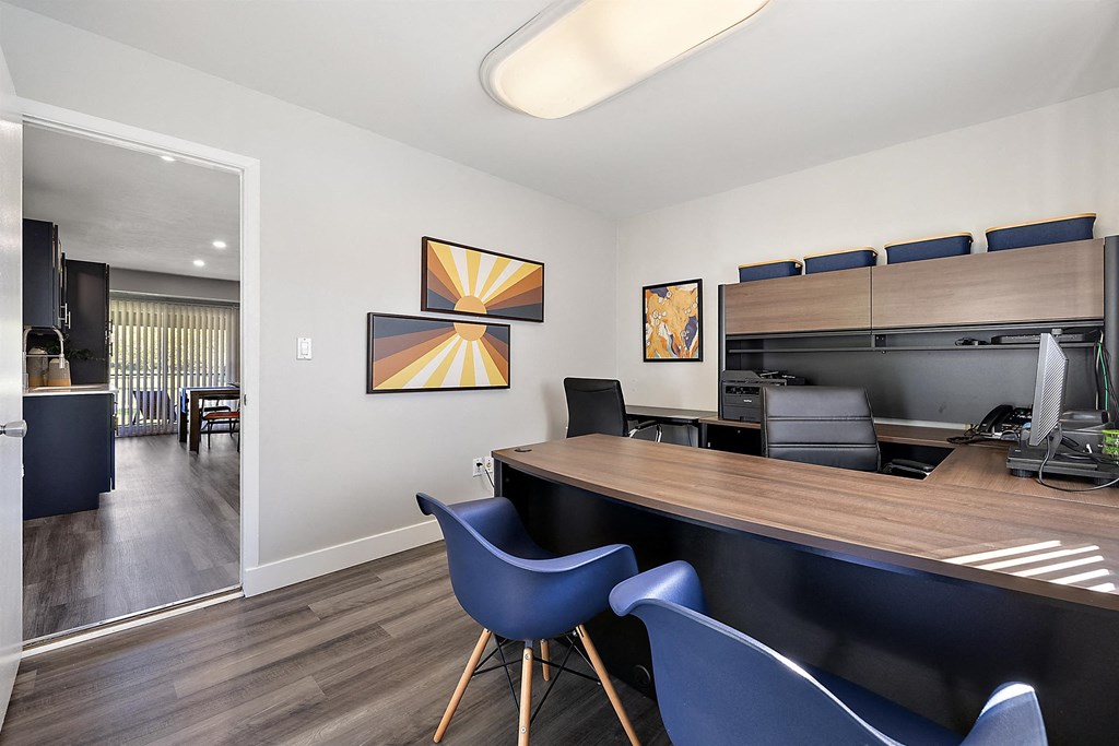 a dining room with a table and chairs and a kitchen at Sunnymede Apartments - Troy, MI, Troy