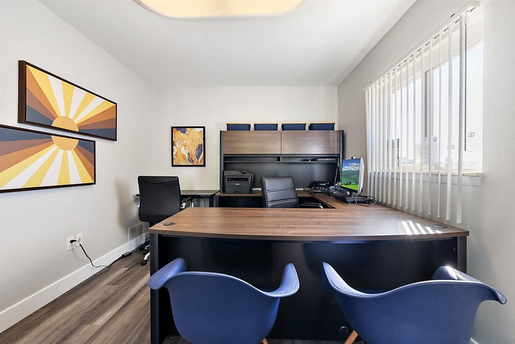 an office with a large desk with chairs and a computer at Sunnymede Apartments - Troy, MI, Troy, Michigan