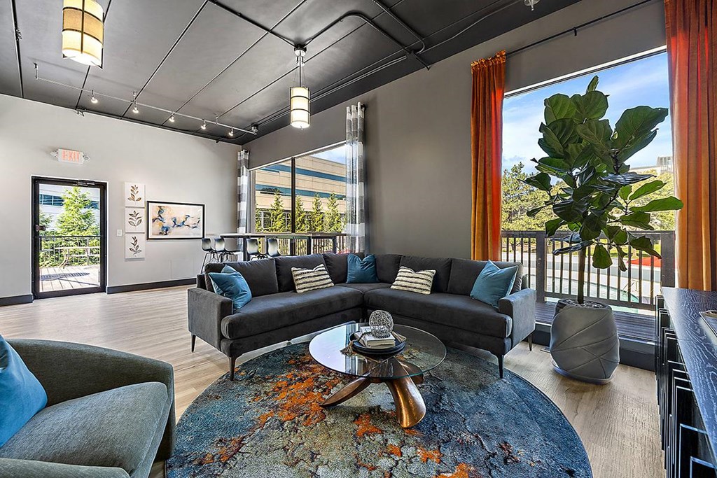 a living room with couches and a table at Troy Place Apartments - Troy, MI, Troy, Michigan