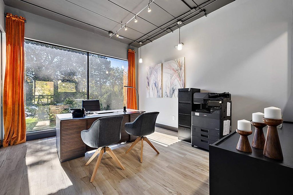 a home office with a desk and a large window at Troy Place Apartments - Troy, MI, Troy, Michigan