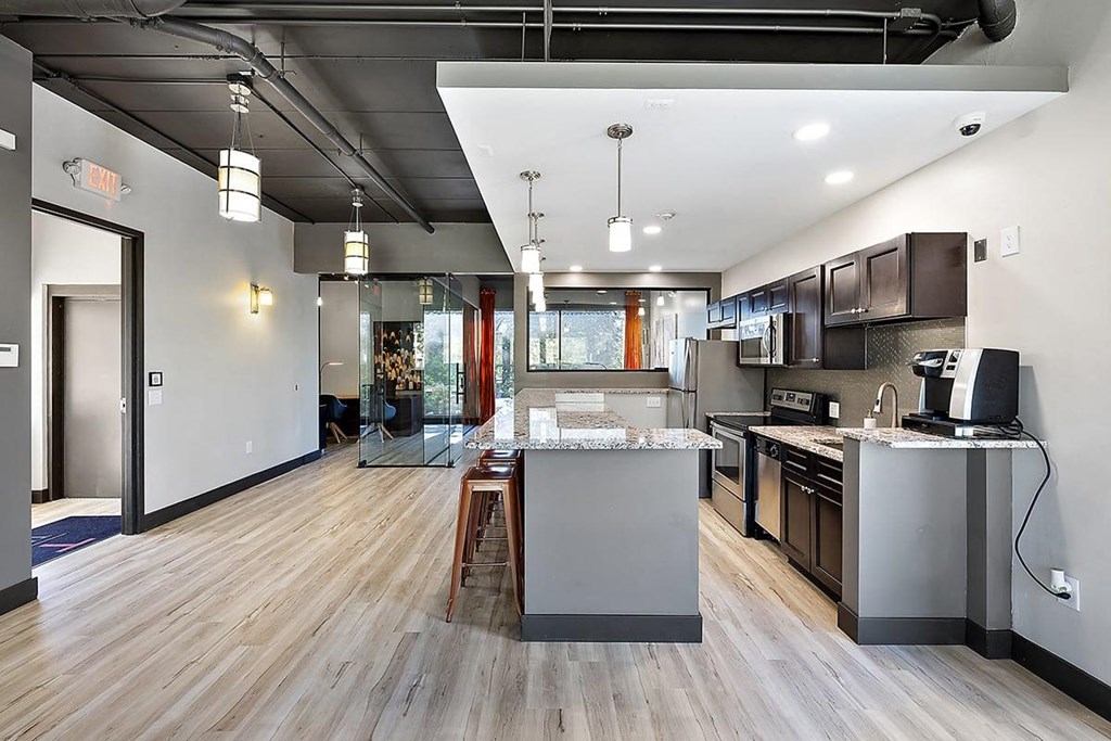 an open kitchen and living room with a large island at Troy Place Apartments - Troy, MI, Troy, Michigan