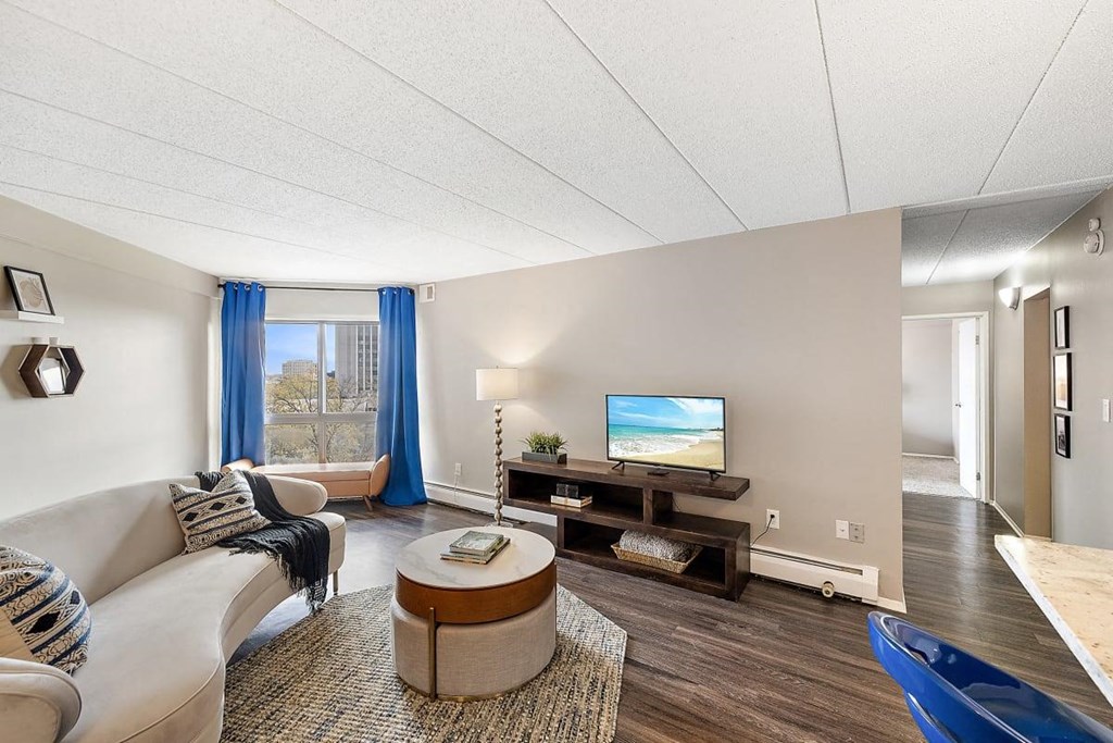 a living room with a couch and a tv at Troy Place Apartments - Troy, MI, Troy, Michigan