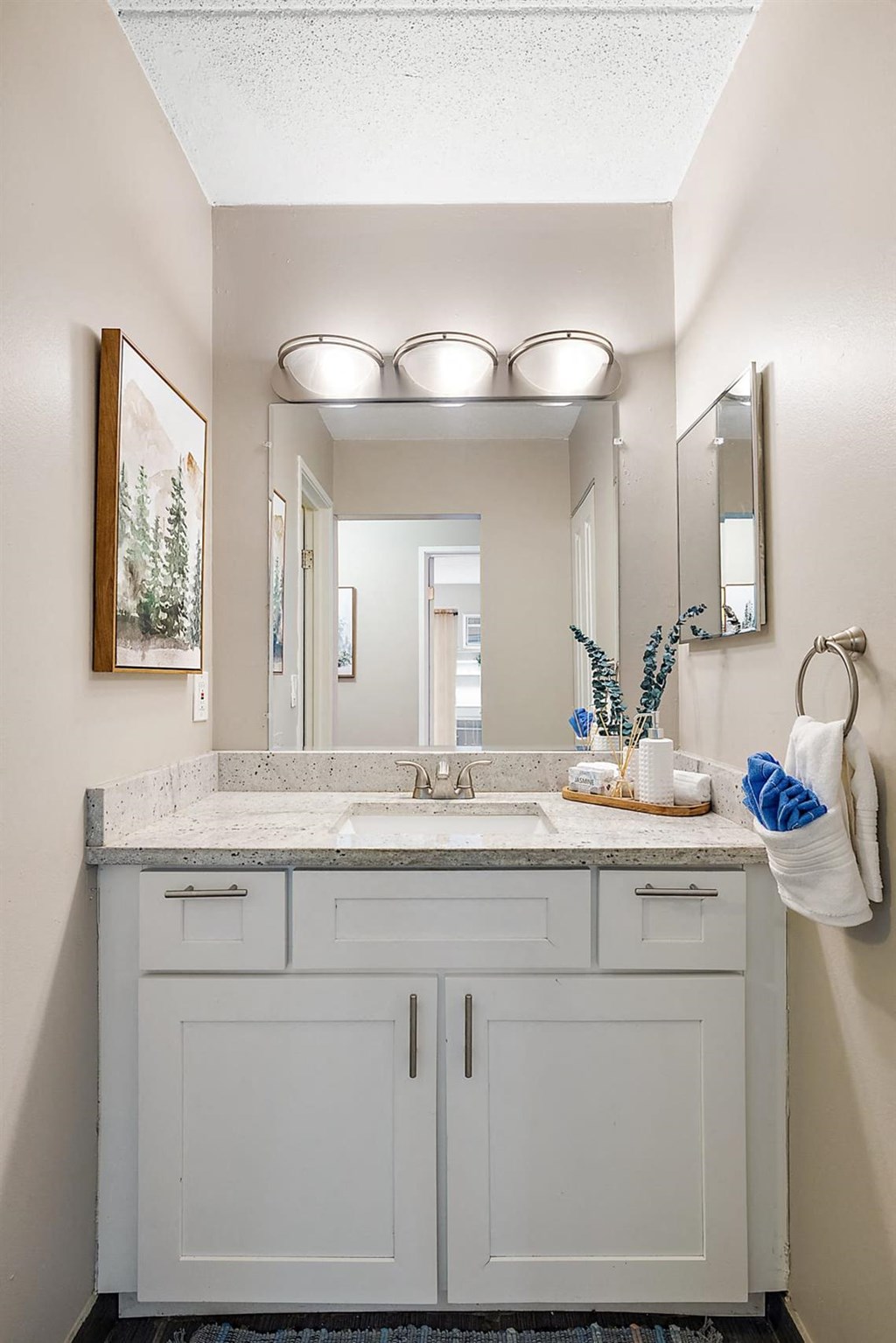 a bathroom with a sink and a mirror at Troy Place Apartments - Troy, MI, Troy