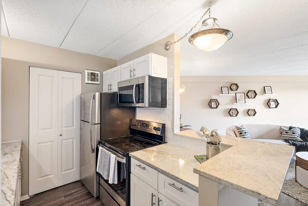 a kitchen with stainless steel appliances and a counter top at Troy Place Apartments - Troy, MI, Troy, 48084