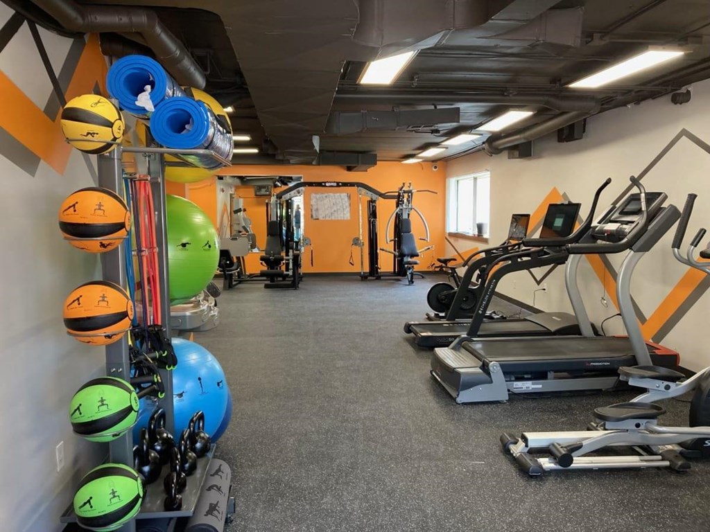 a gym with a lot of exercise equipment in it at Troy Place Apartments - Troy, MI, Troy, Michigan