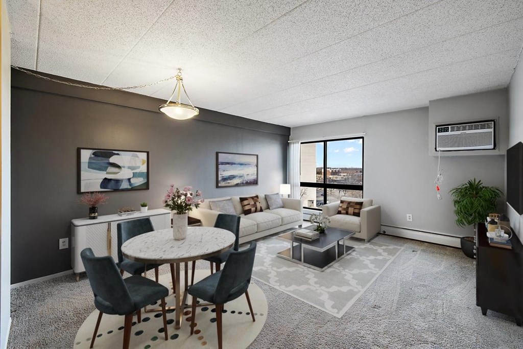 a living room with a table and a couch at Troy Place Apartments - Troy, MI, Troy, 48084