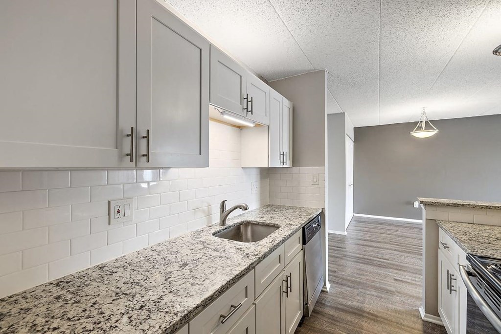 a kitchen with white cabinets and a sink at Troy Place Apartments - Troy, MI, Troy