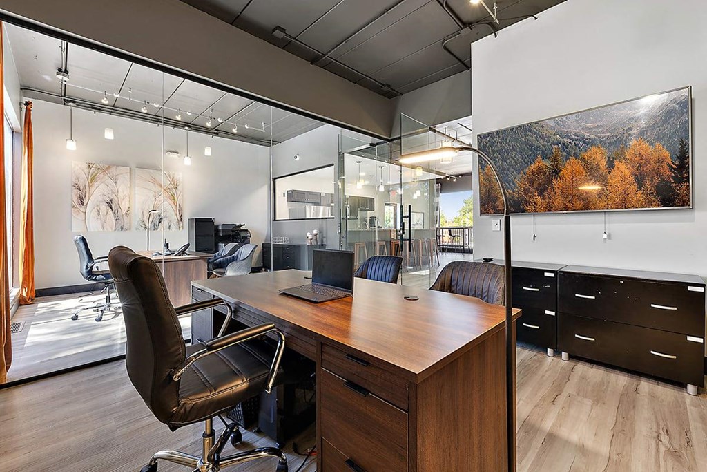 a home office with a desk and a large window at Troy Place Apartments - Troy, MI, Michigan