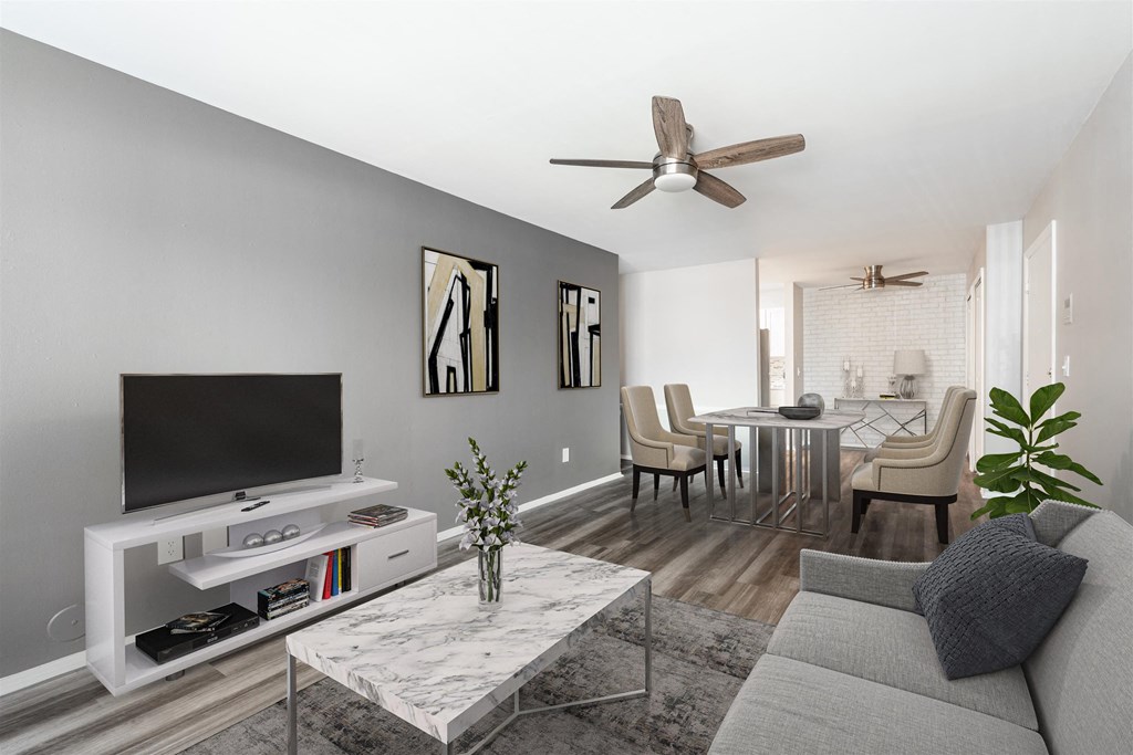 a living room with a couch and a tv at Town & Country Apartments - Wixom, MI, Wixom, 48393