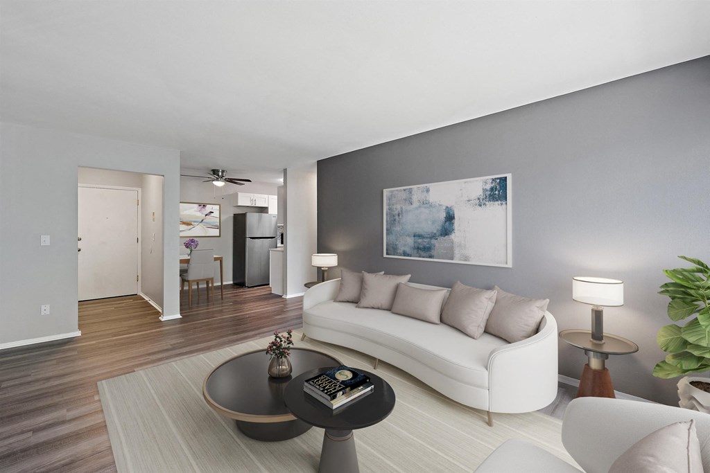 Living with a white couch and a coffee table at Town & Country Apartments - Wixom, MI, Michigan