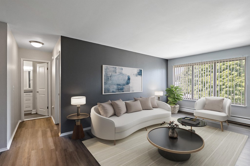 a living room with a white couch and a table at Town & Country Apartments - Wixom, MI, Wixom, Michigan