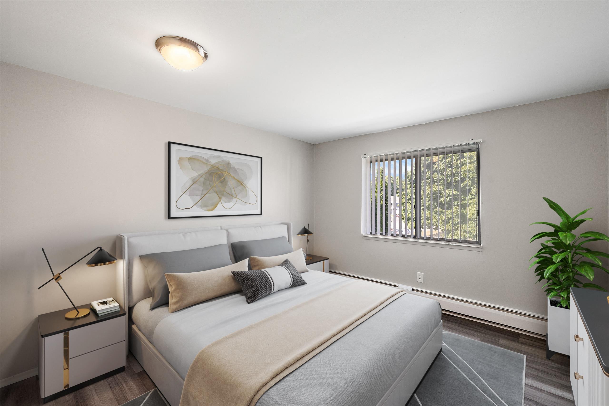 a bedroom with a large bed and a window at Town & Country Apartments - Wixom, MI, Wixom, 48393