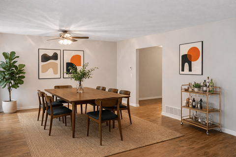 A dining room with a wooden table and chairs.