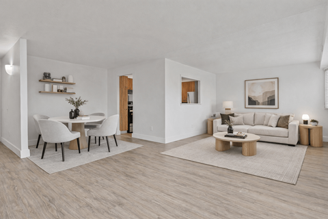 A modern living room with a dining table and a couch.