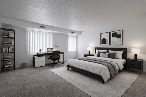A bedroom with a bed, desk, and chair.