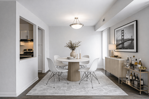 A dining room with a white table and chairs.