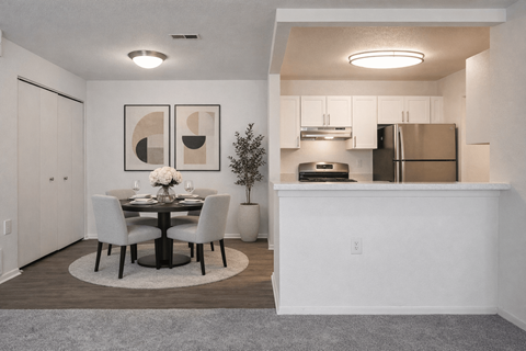 A modern dining room with a table set for two.