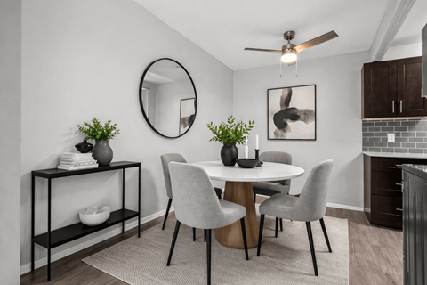 Dining area with round table and upholstered chairs at Plymouth Heritage Apartments, Michigan, 48170
