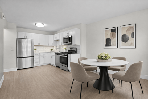 A modern kitchen with a dining table set for four.