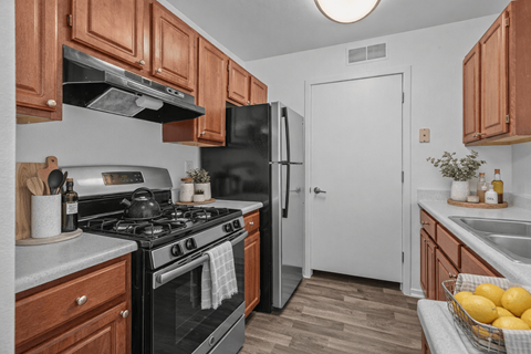 A kitchen with a black stove and a black refrigerator.
