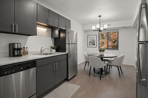 A modern kitchen with a dining table and chairs.