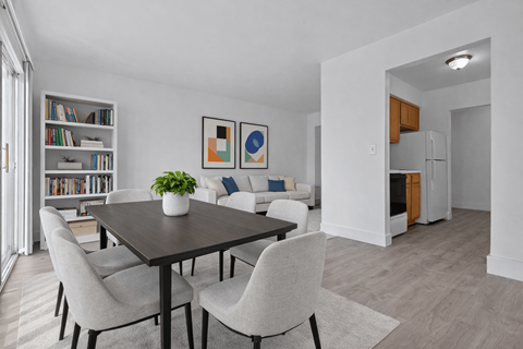 A dining room with a table and chairs.