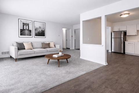 A modern living room with a white couch and a coffee table.