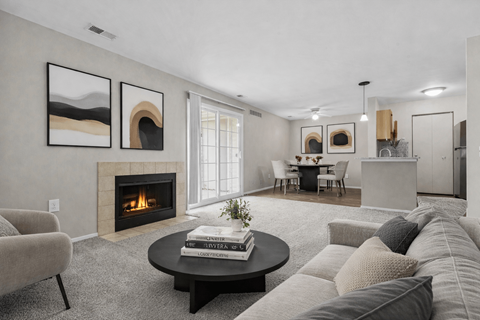A living room with a fireplace and a painting on the wall.