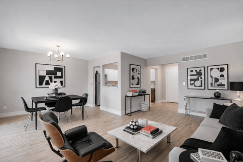 A modern living room with a dining table and chairs.