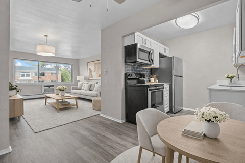 A modern kitchen with a dining table set for two.
