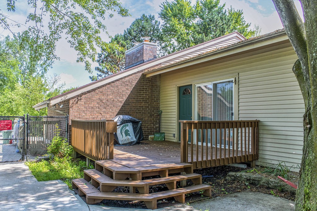 the front of a house with a porch and a deck