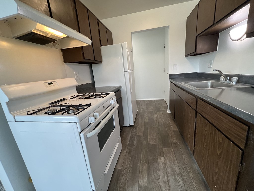 a kitchen with a stove sink and refrigerator