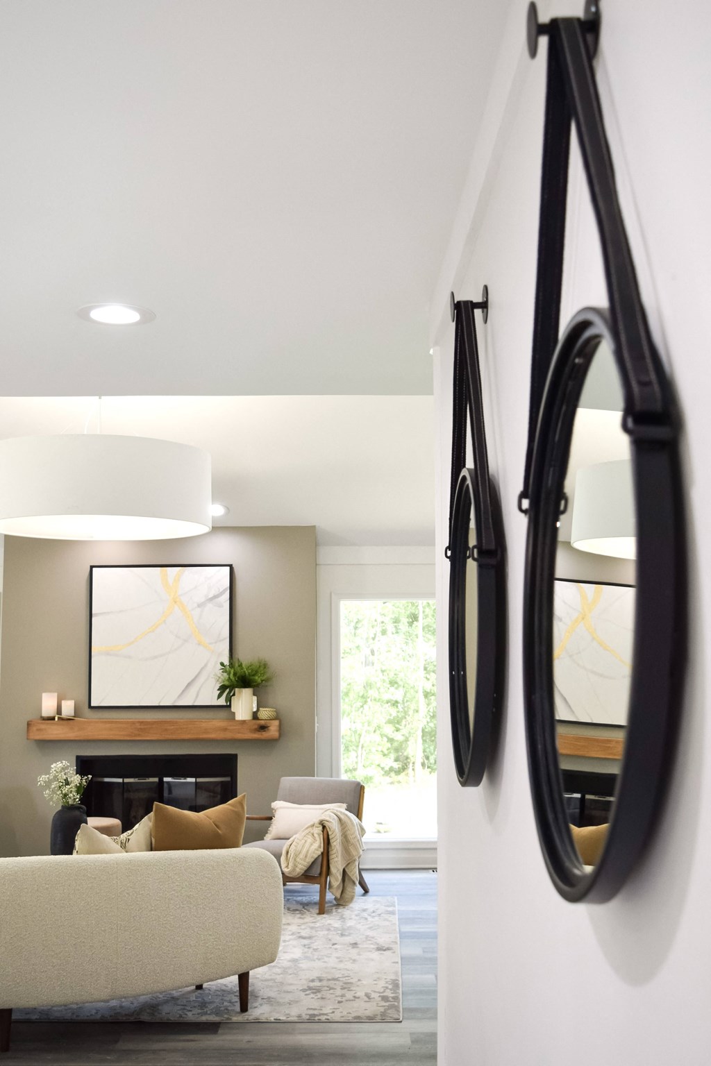 a living room with a couch and mirrors on the wall