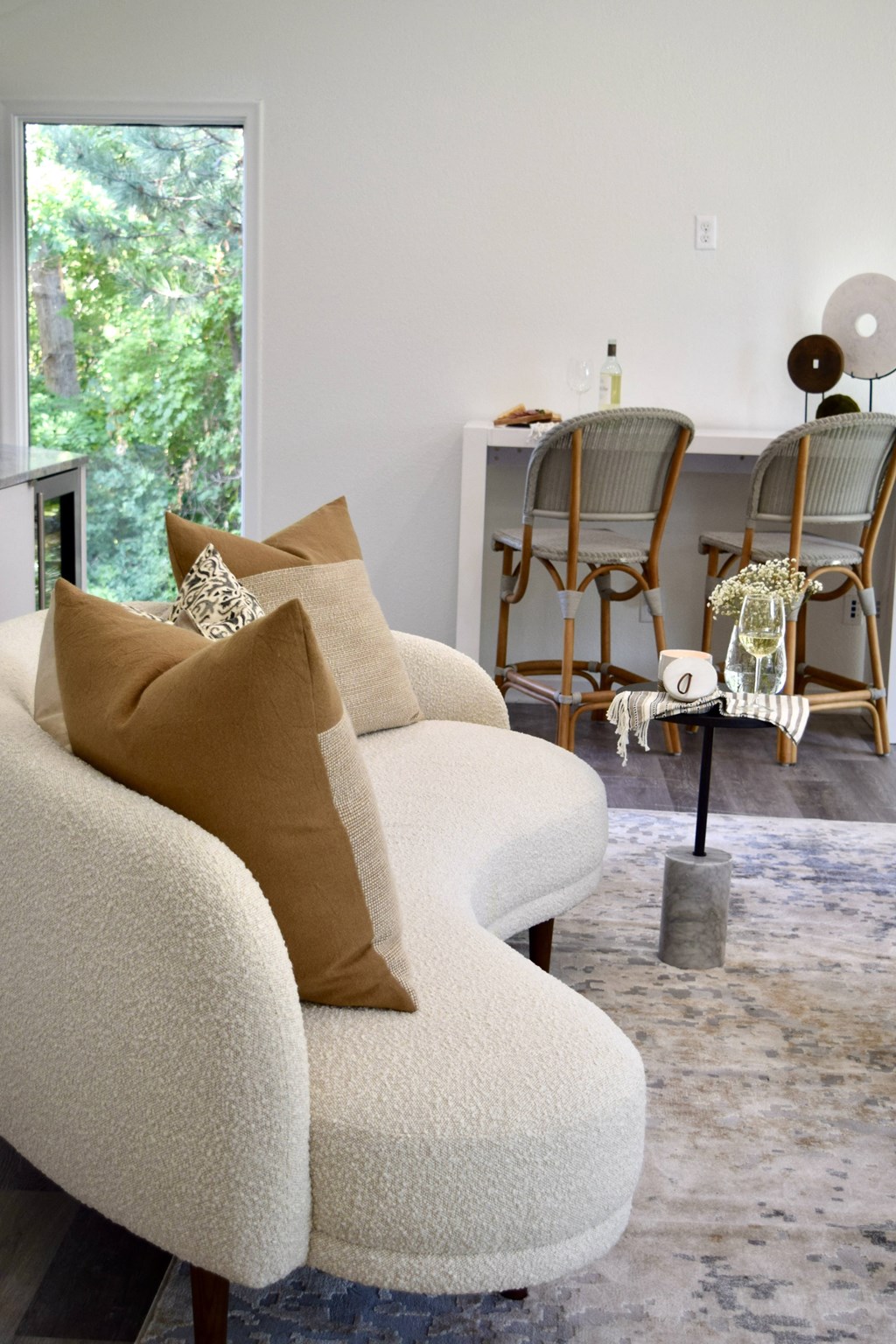 a living room with a white couch and chairs and a table