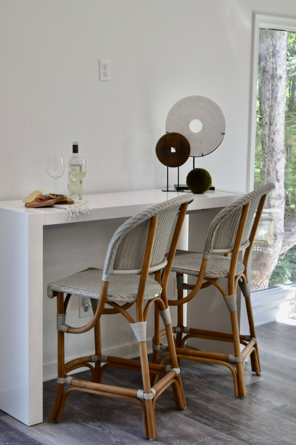 two wooden chairs sitting at a bar next to a kitchen counter