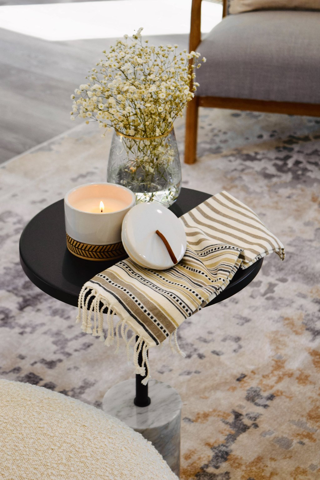 a table with candles and a vase with flowers on it