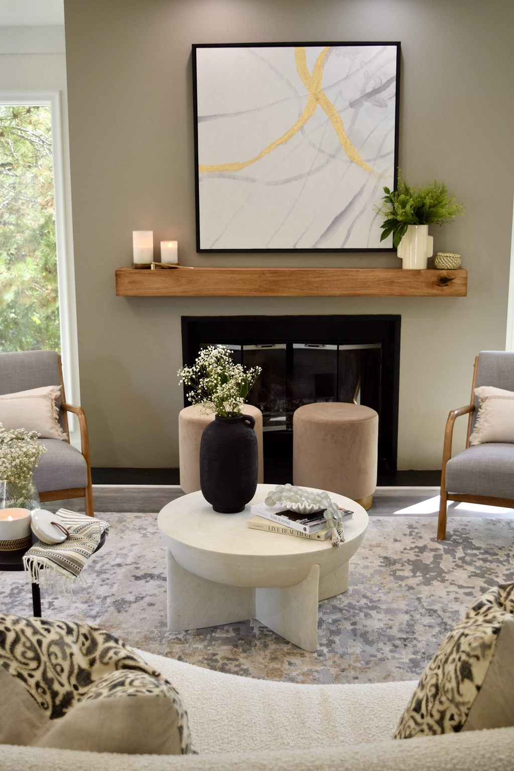 a living room with a fireplace and a white coffee table