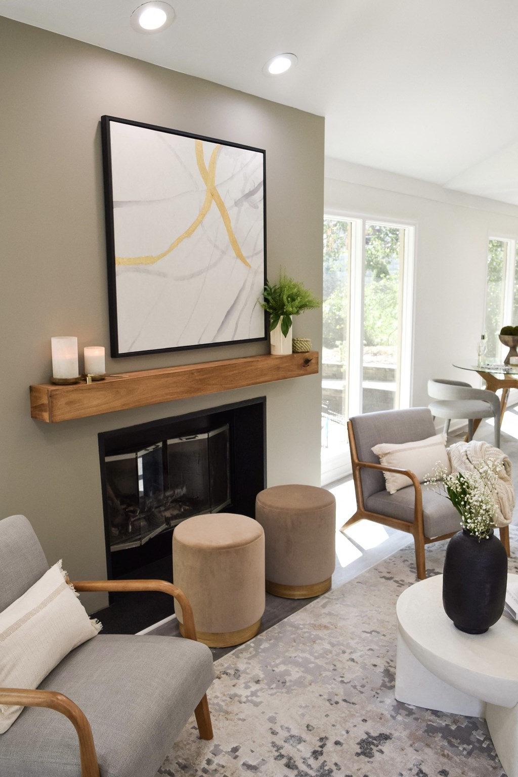 a living room with a fireplace and a painting on the wall