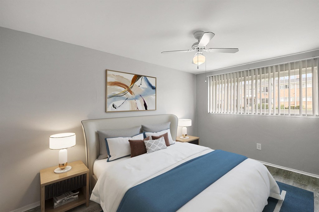 a bedroom with a large bed and a ceiling fan