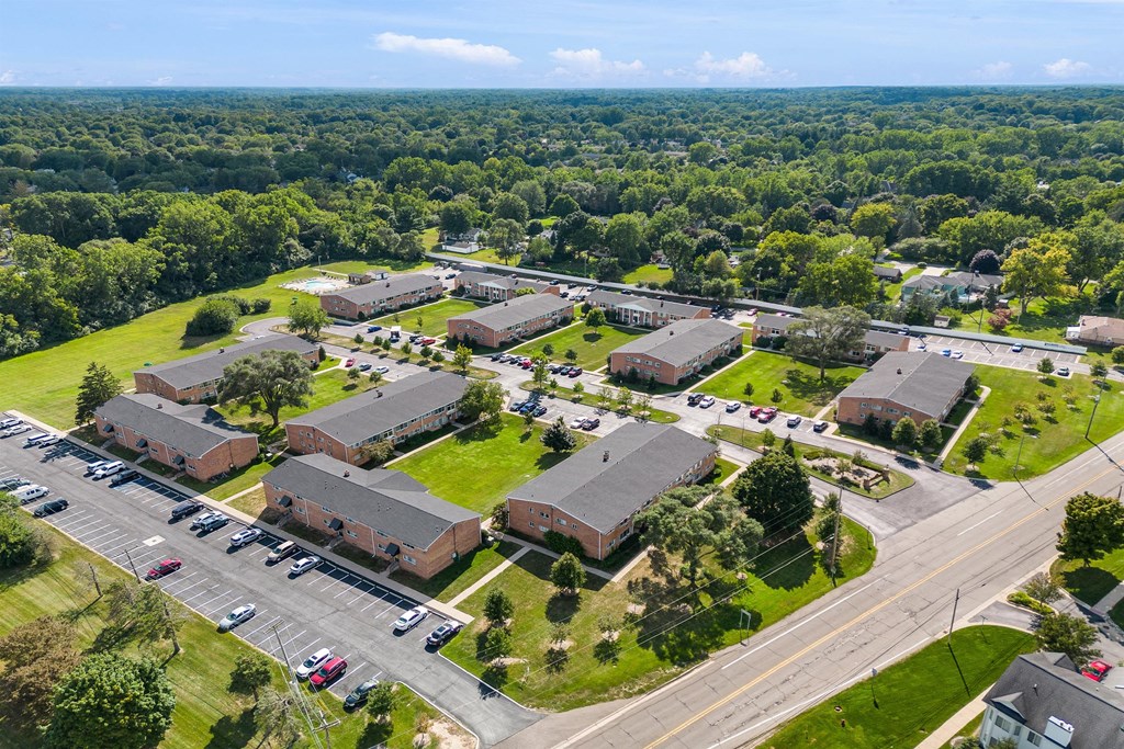 an aerial view of a neighborhood of buildings and a parking lot