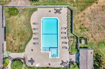 arial view of a swimming pool and patio with umbrellas