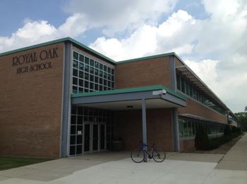 A bike is parked in front of Royal Oak High School.