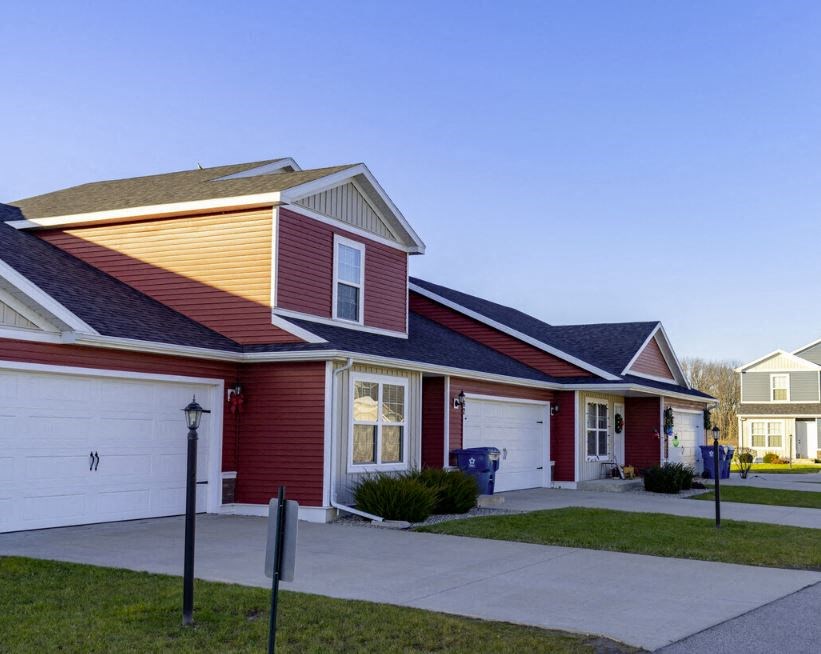 a red house with a sidewalk in front of it