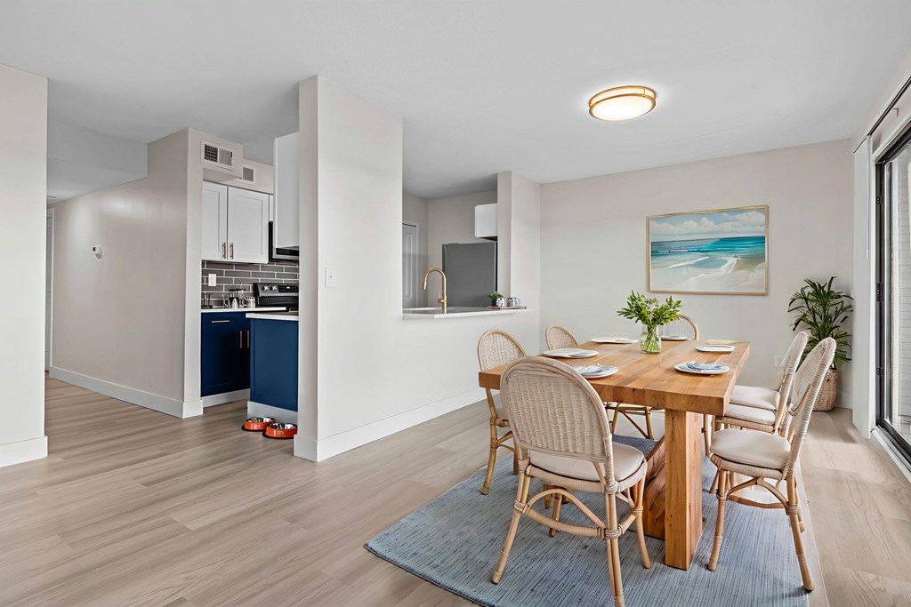A dining room with a table set for four.