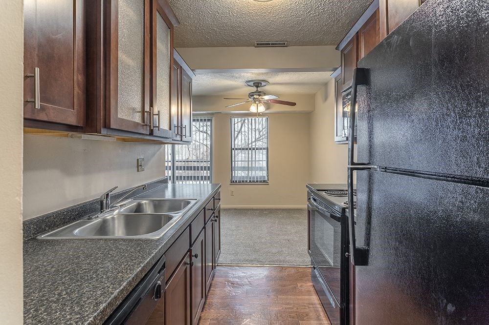 a kitchen with a sink and a refrigerator