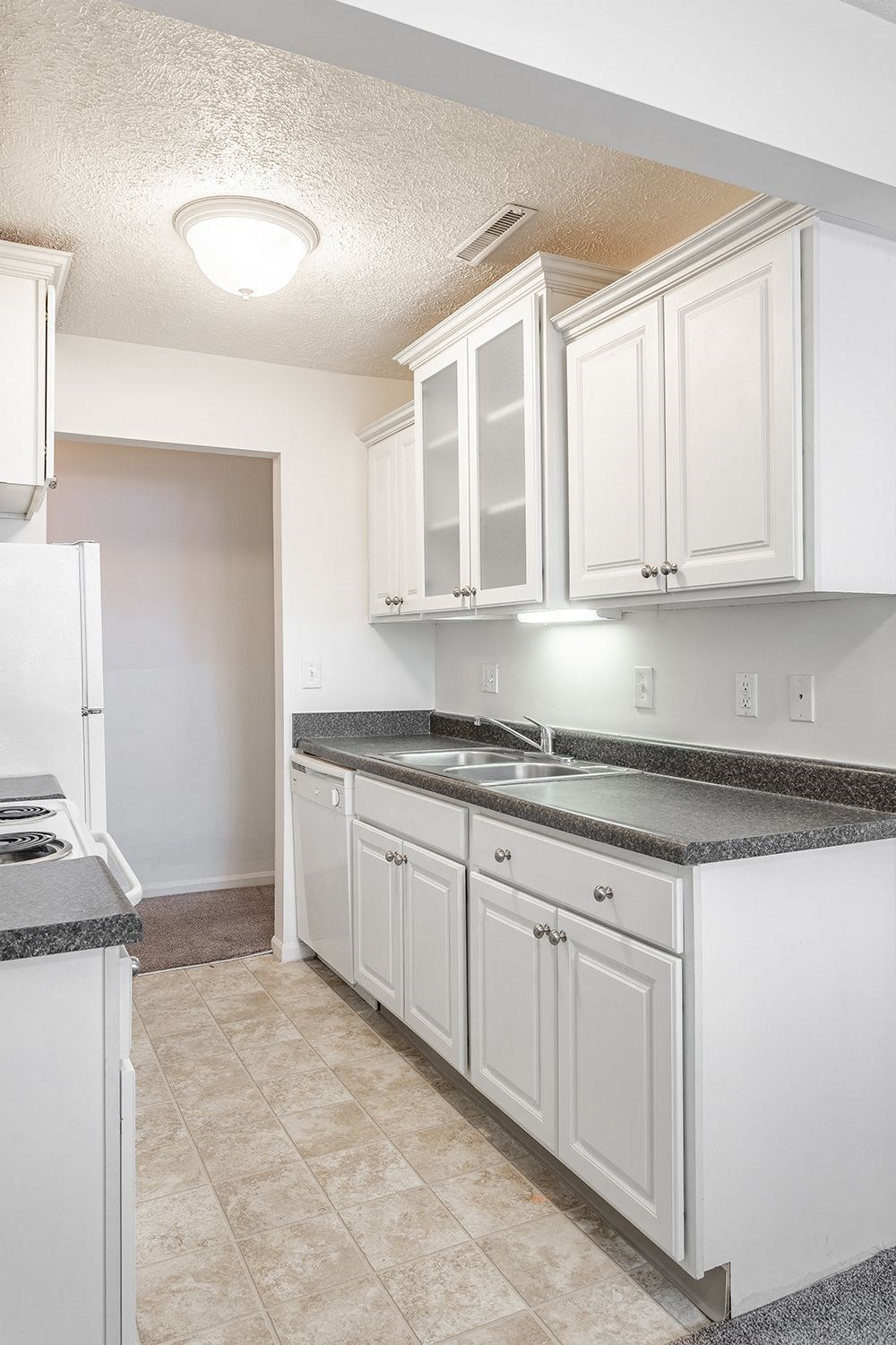 a kitchen with white cabinets and a counter top