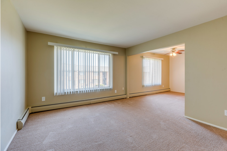 the living room of an empty house with large windows