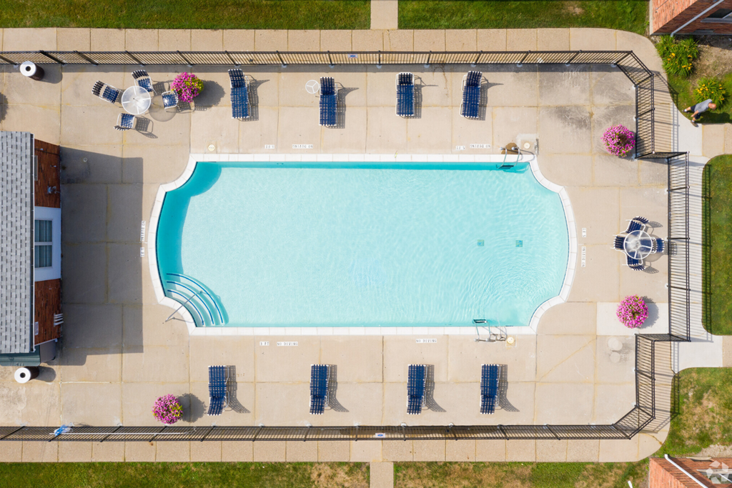 arial view of a swimming pool with umbrellas around it