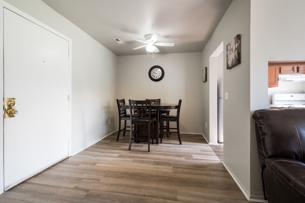 a dining room with a table and chairs and a kitchen